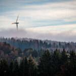 Forest with wind turbine in clouds