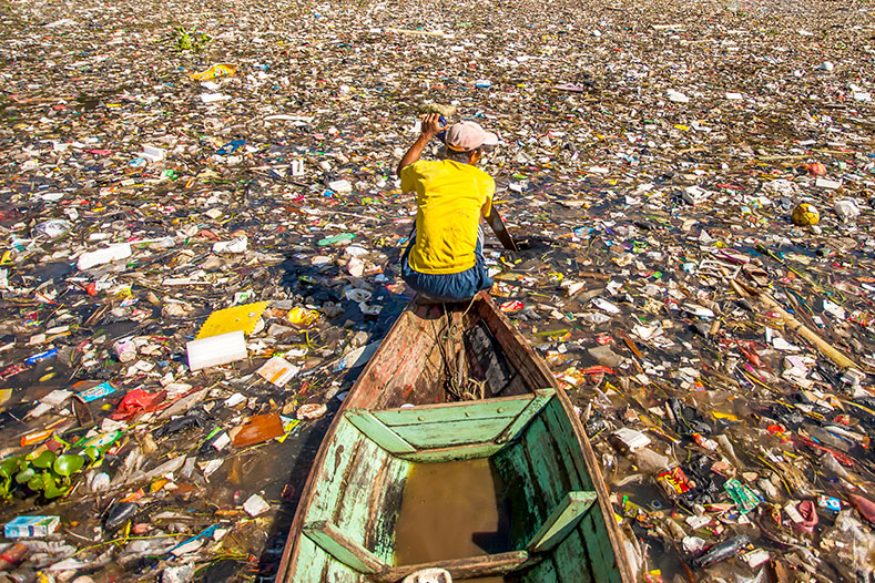 Man rowing boat through plastic